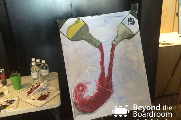 painting of a wine glass with 2 bottles of red pouring into it